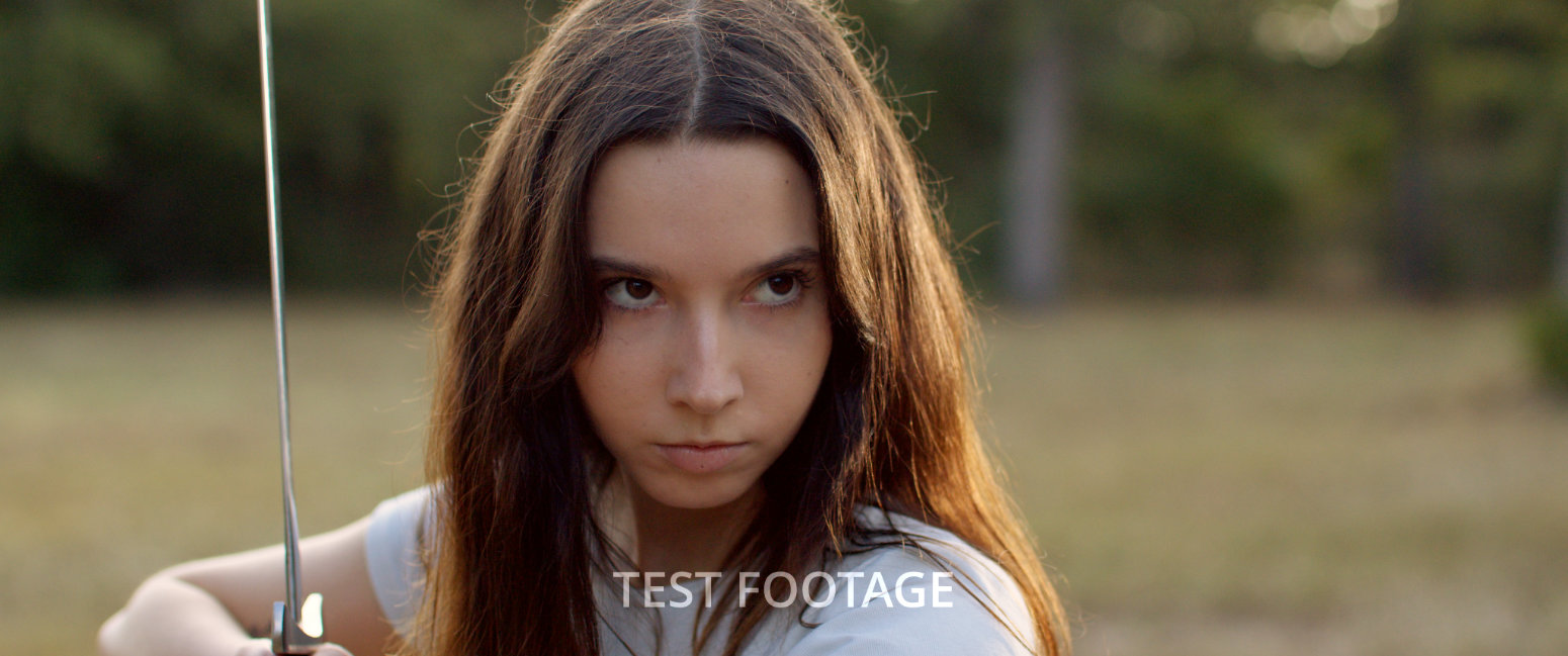 Ava holding a sword and looking determined and ready to fight